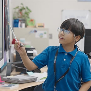 student at the whiteboard with marker