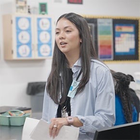 Kings Ridge teacher holding a paper