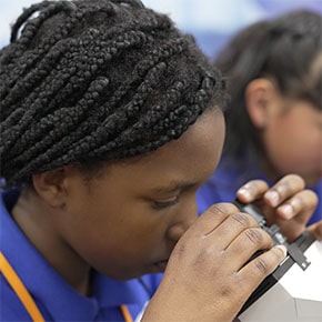 student looking into a microscope