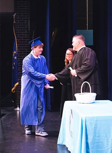 Student walking across stage at graduation