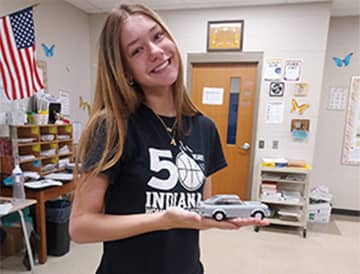 Student holding a toy car