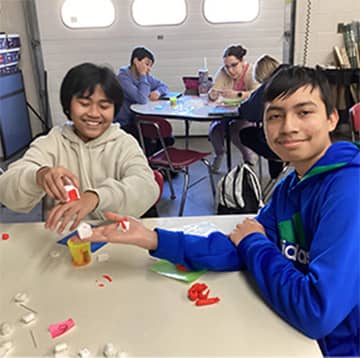 Two students showing their project