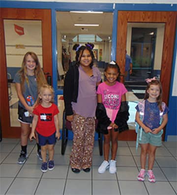 Students in front of classroom doors