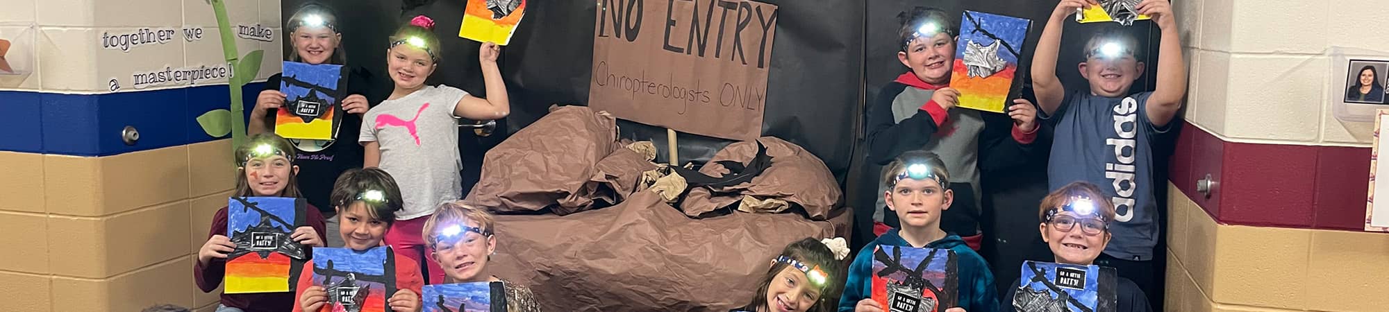 students dressed as miners next to a sign that reads No Entry