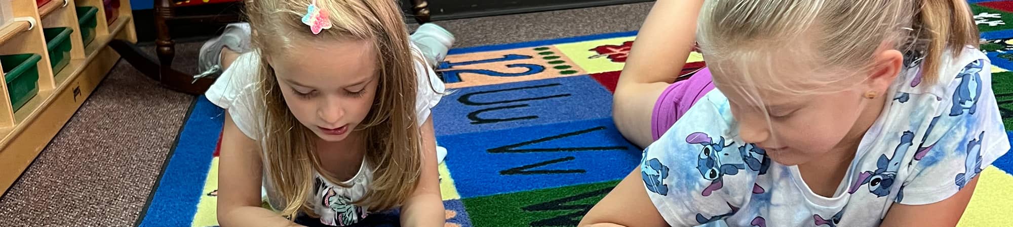 students laying on the floor to read