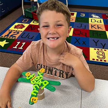 student showing their art creation