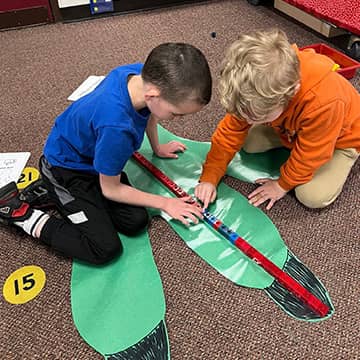 two students working together on an art project
