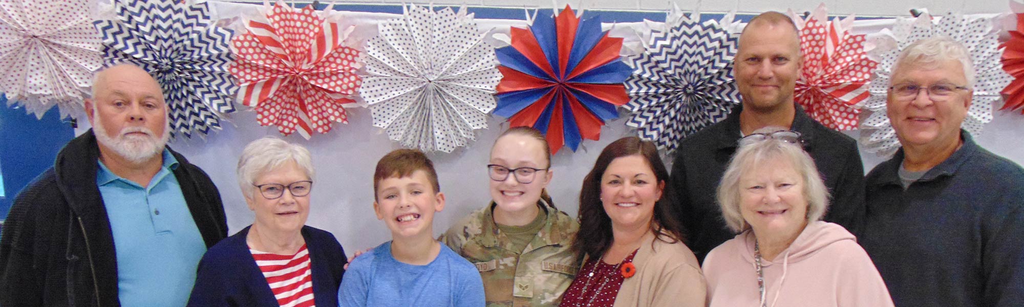 Staff members smiling with some students