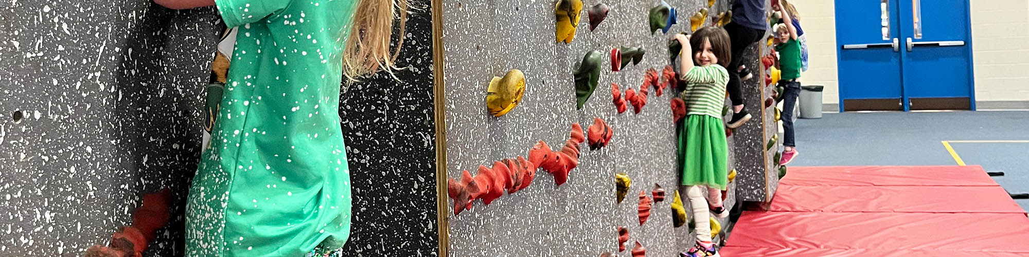 Happy students engaged in a rock climbing activity