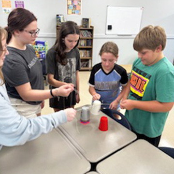 Group of students working on a project together in the classroom