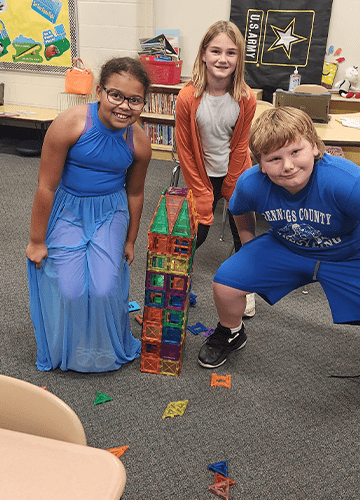 Three students with a magnatiles tower