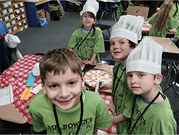 Four students in chef hats