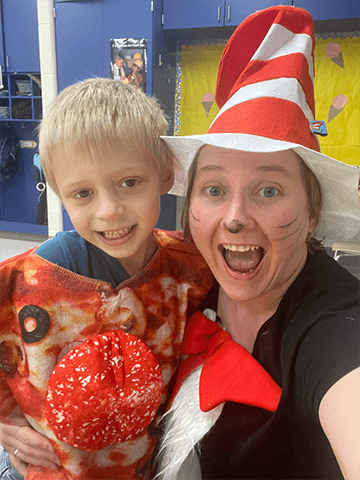 Student with a teacher dressed as cat in the hat