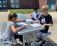 Students outside writing