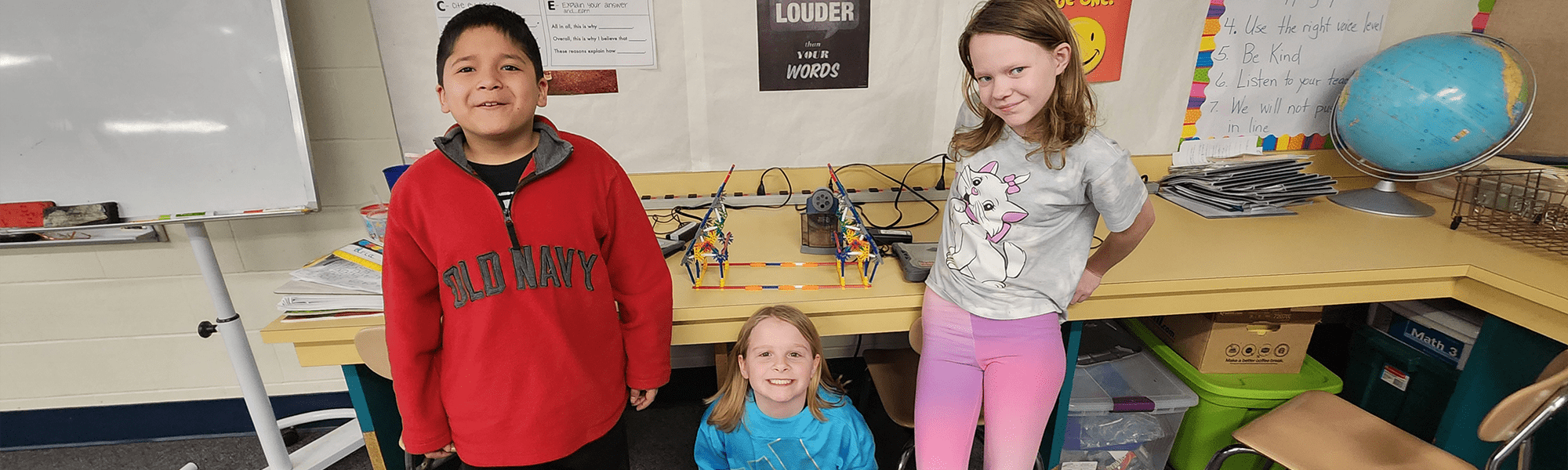 Three students showing their project
