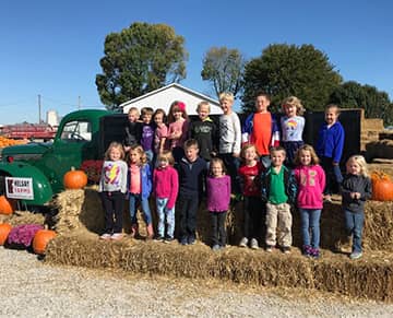 students at a pumpkin farm