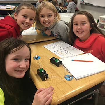 Four smiling students