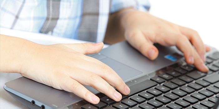 Close up of a student using a laptop computer