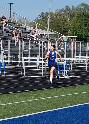 Student running on a track
