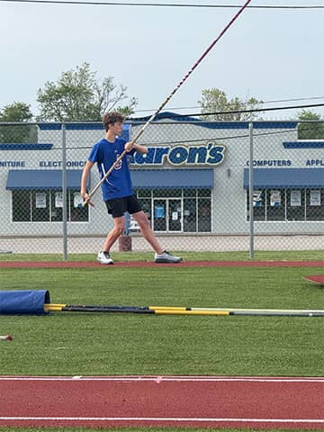 Student pole vaulting