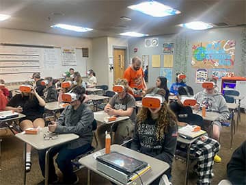 Students in a classroom using vr head sets