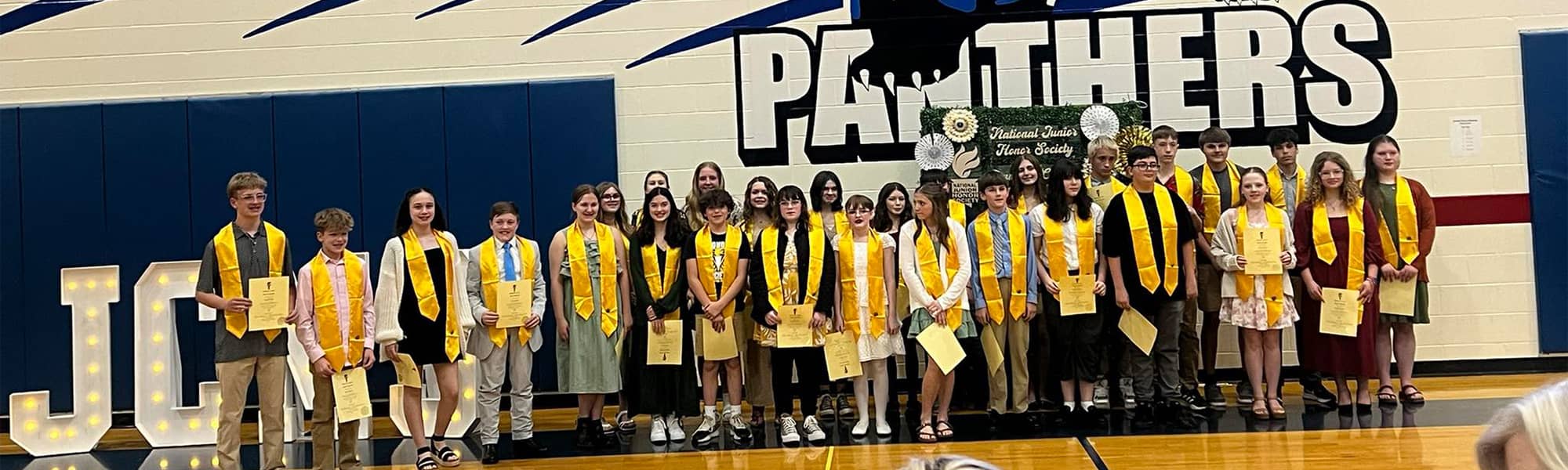 Graduating class against a wall