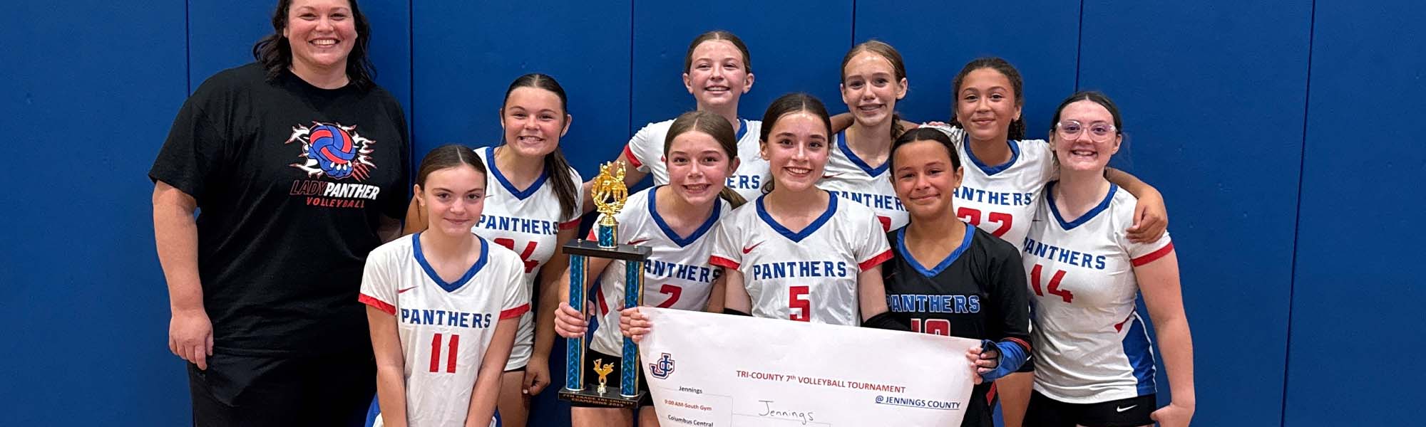 Volleyball team holding trophy