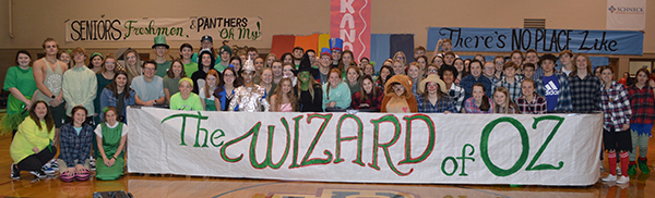 Students in costume behind a sign that reads The Wizard of Oz