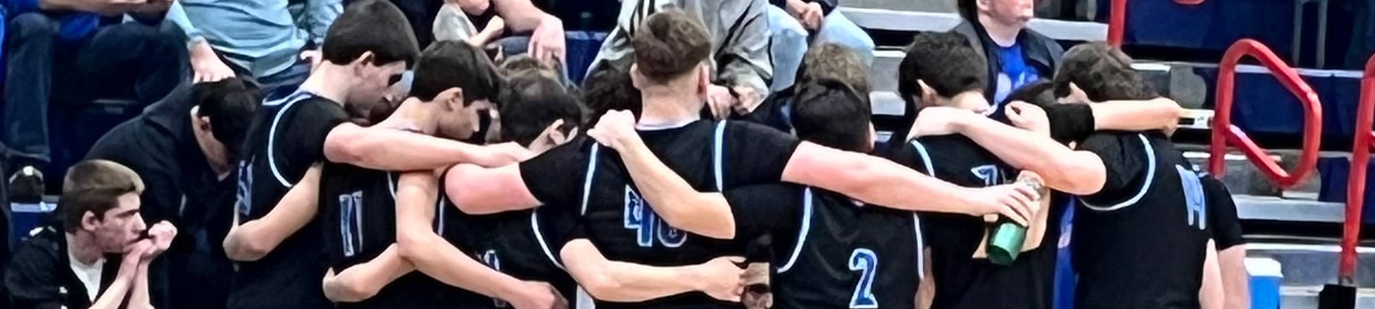 team with arms around each other