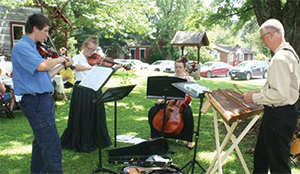 Eric Jarboe plays instruments outside with other people
