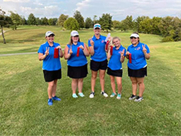 golfers holding up red ribbons