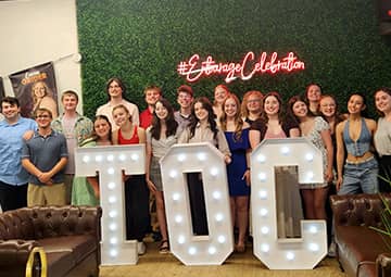 students behind a TOC sign