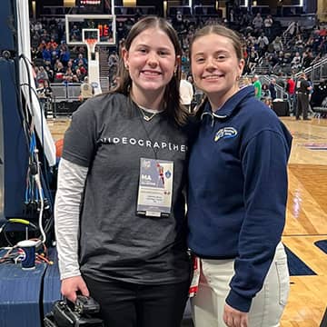 two students at an event in the gym