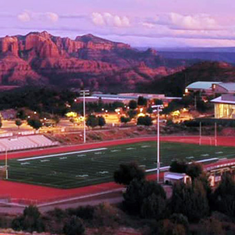 Beautiful view of football field with mountains in the background
