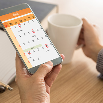 Parent looking at a calendar on a mobile device