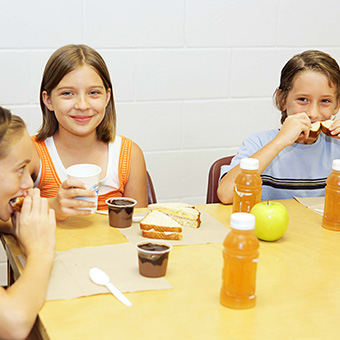 Happy students eating at a lunch table