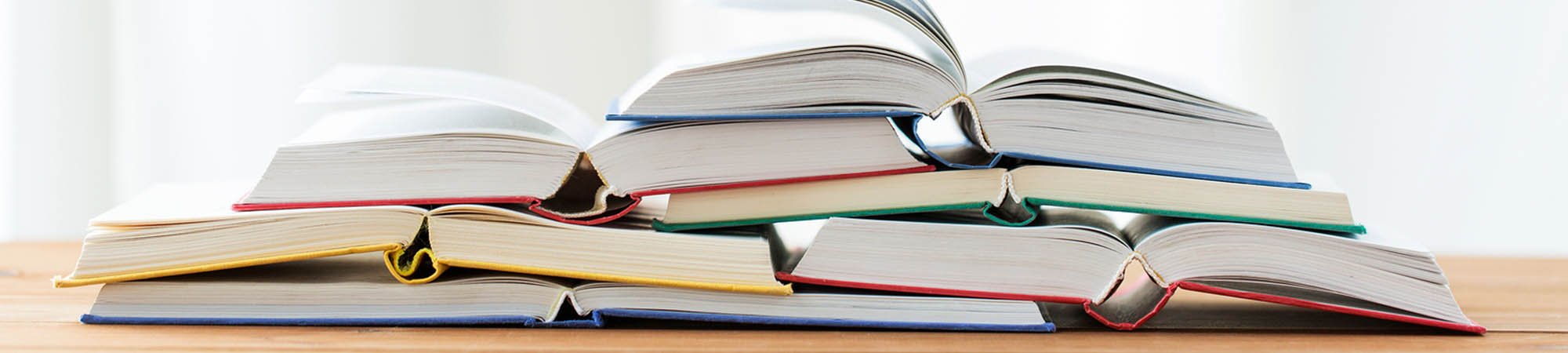 A collection of books opened on a table