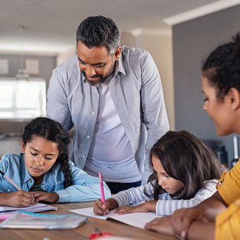 Parents helping their children complete homework