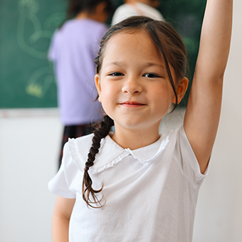 Elementary school girl raising her hand