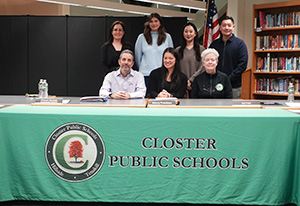 School board members behind Closter Public Schools banner