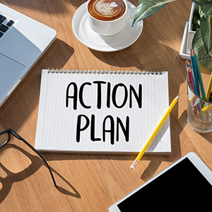 notepad with the words Action Plan on it