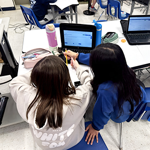 Students working in the classroom with laptops