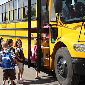 kids loading onto a school bus