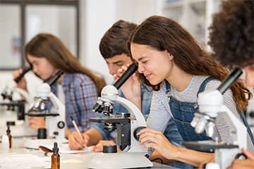 Students using microscopes