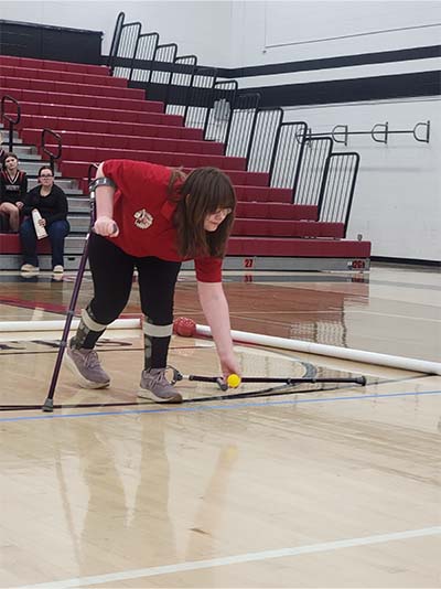girl rolling the starter boccer ball