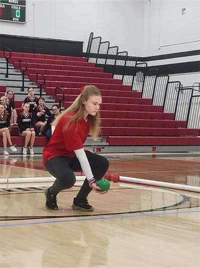 Girl rolling a bocce ball