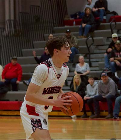 boy in white holding a basketball