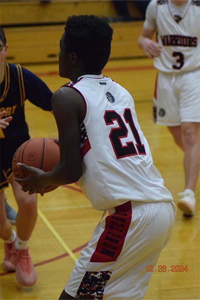 boy in white about to shoot