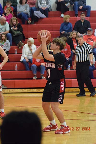 boy in black shooting a free throw