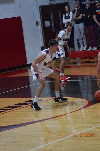 boy in white guarding